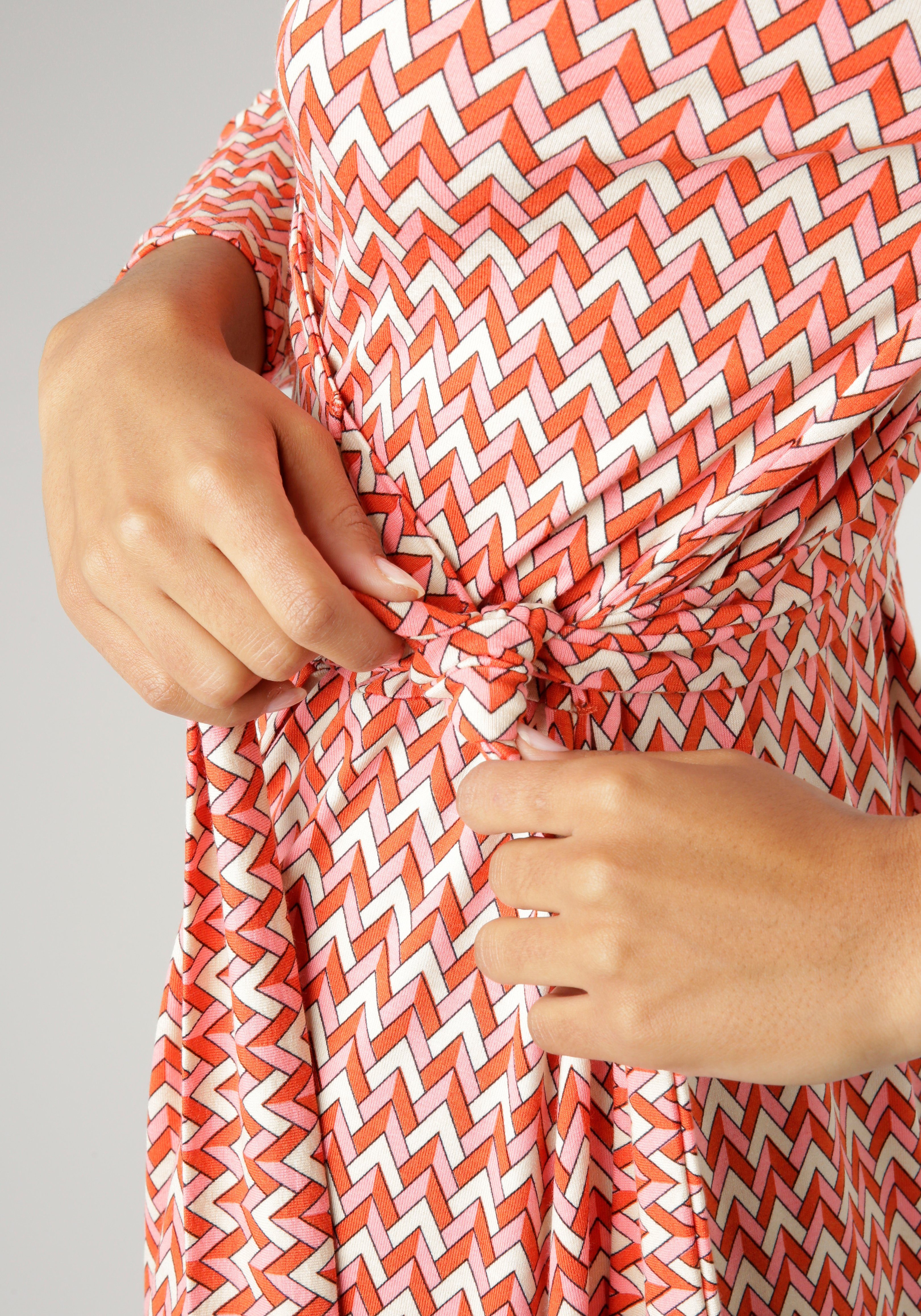 Aniston SELECTED Jerseyjurk met geometrisch patroon en strikdetails aan de zijkant nieuwe collectie