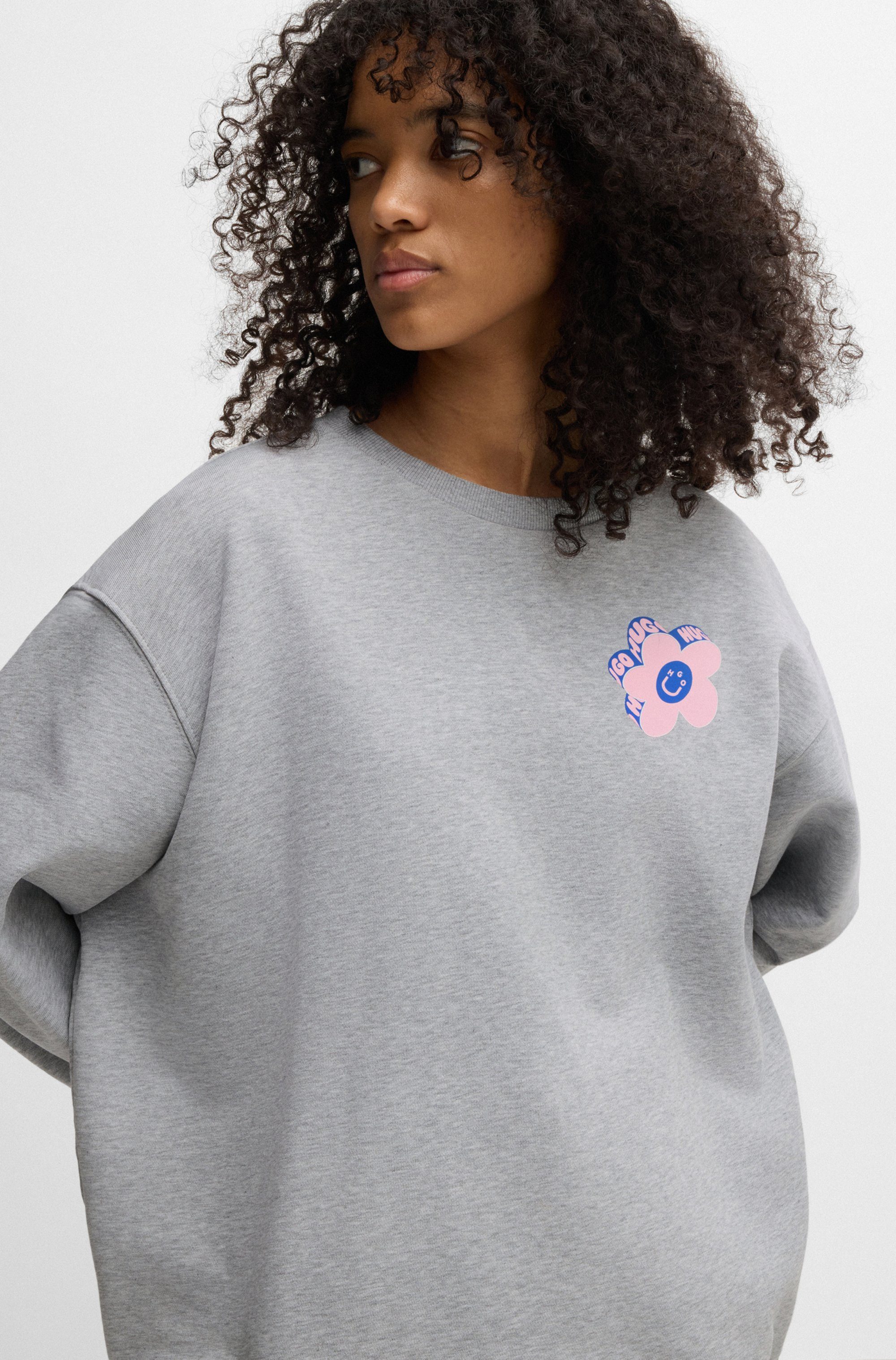 HUGO Blue Sweatshirt Oversized crew met bloemenprint op de achterkant, straß logo print