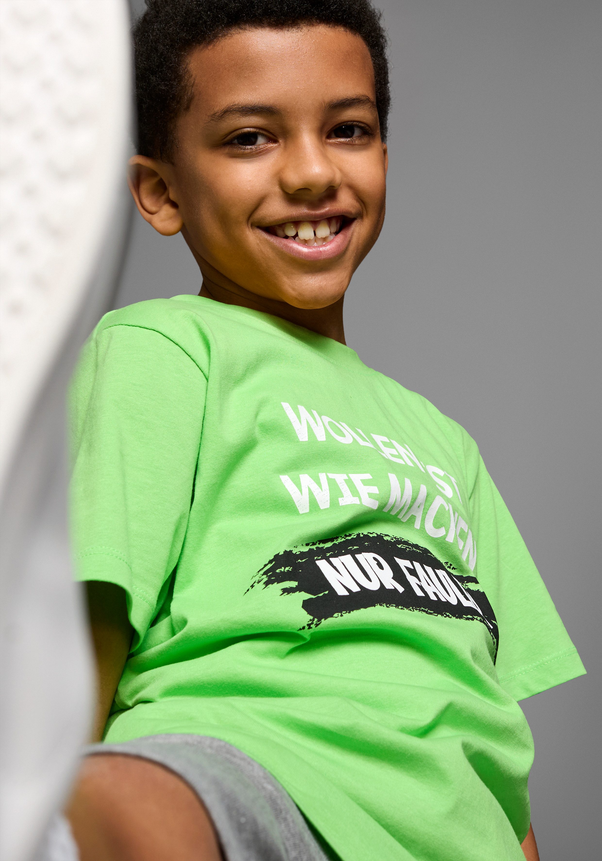 KIDSWORLD T-shirt Met spreuk: WOLLEN IST WIE MACHEN.... Korte mouwen, basic pasvorm, bedrukt, ronde hals